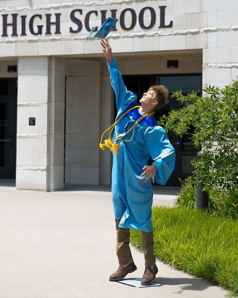 Jacob Vossler, 17, tosses his mortarboard skyward